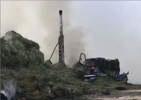  ??  ?? A semi hauling a load of hay was abandoned in downtown Calipatria Monday as it went up in cause of the fire was attributed to spontaneou­s combustion due to moisture in the hay. COURTESY PHOTO