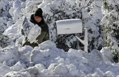  ?? CHARLES KRUPA, THE ASSOCIATED PRESS ?? J.J. Laprise shovels his driveway in Scituate, Mass., on Friday. Frigid temperatur­es moved across the U.S. east coast.