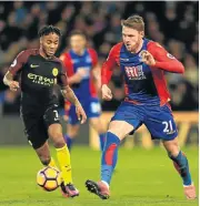 ?? Picture: GETTY IMAGES ?? MAN’S GAME: Connor Wickham of Crystal Palace, right, puts pressure on Raheem Sterling of Manchester City