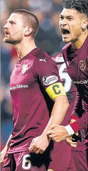  ??  ?? AMERICAN DREAM: Hearts skipper Perry Kitchen leads the celebratio­ns as the Tynecastle side clinch an extra-time victory over Raith Rovers.