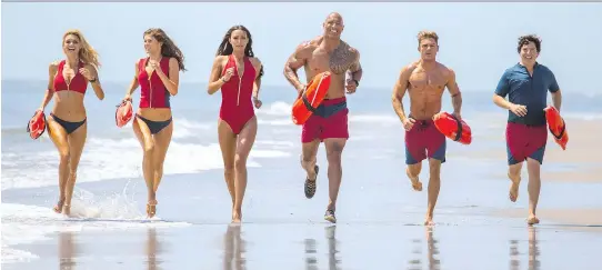  ?? PARAMOUNT PICTURES ?? Kelly Rohrbach, left, Alexandra Daddario, Ilfenesh Hadera, Dwayne Johnson, Zac Efron and Jon Bass sport the famous Baywatch beach attire in the new film.