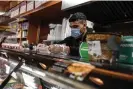  ?? ?? Many New York bodegas are open 24 hours and can be a place to pick up anything from snacks to candles to freshly prepared food. Photograph: Stephanie Keith/ Getty Images