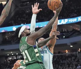  ?? JOVANNY HERNANDEZ / JOURNAL SENTINEL ?? Bucks guard Patrick Beverley puts up a shot against Hornets forward Miles Bridges on Friday at Fiserv Forum. Beverley played 12 minutes and had six points in his first game with Milwaukee.