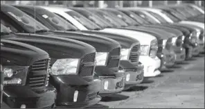  ?? AP/ JOHN BAZEMORE ?? Ram pickups sit on a lot at Landmark Dodge Chrysler Jeep RAM in Morrow, Ga. Automakers reported strong U. S. sales Tuesday, the best two- month stretch in 15 years.