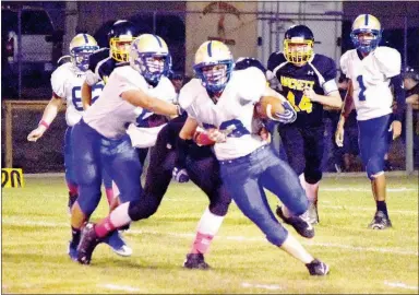  ?? Westside Eagle Observer/MIKE ECKELS ?? A Bulldog running back breaks through a swarm of Hornets last season with help from a few teammates during the Decatur-Hackett football contest in Hackett on Oct. 6. James Ortiz will take over as head football coach this season as the Bulldogs...