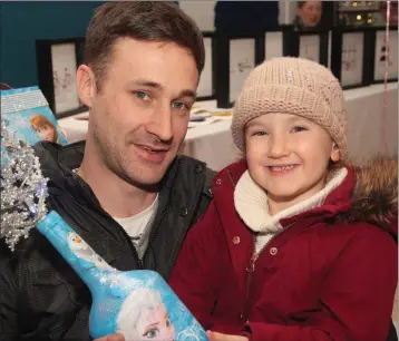  ??  ?? Tony Travers with his daughter, Grace at the Christmas craft fairs in Gorey Shopping Centre.