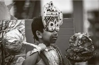  ??  ?? A young contestant wears a too-big crown as he competes dressed as Lord Krishna lifting Govardhana mountain on his finger in 2018. Diwali celebrates the triumph of light over darkness.