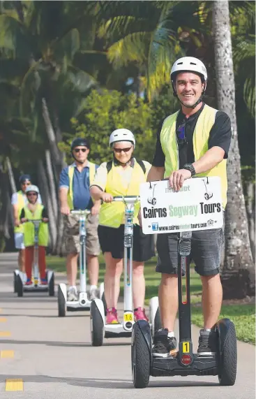  ?? Picture: BRENDAN RADKE ?? LET’S ROLL: Co-owner of Cairns Segway Tours Craig Chalmers leads a group out on a tour. The popular business is for sale.