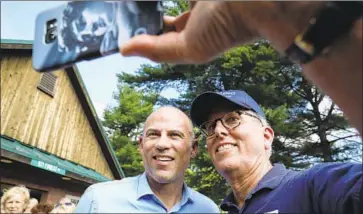  ?? Cheryl Senter Associated Press ?? MIKE MUNHALL of Bennington, N.H., right, gets a selfie with Michael Avenatti after the Greenfield event.