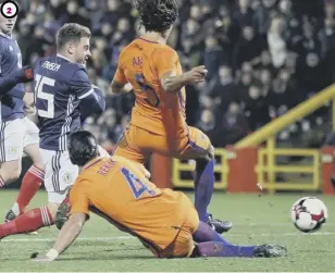  ??  ?? 1 Scotland’s Ryan Christie, left, battles Timothy Fosu-mensah for the ball. 2 Ryan Fraser fires a shot on goal under pressure from Nathan Ake and Karim Rekik. 3 Ryan Jack, left, puts Netherland­s goalscorer Memphis Depay under pressure.