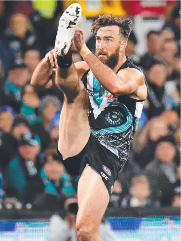  ?? Picture: GETTY IMAGES ?? FEELING GREAT: Port Adelaide’s Charlie Dixon kicks during a game against the Cats last month – the key forward made the most of his injury lay-off to get his body right.