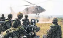  ?? SUBMITTED PHOTO ?? Canadian soldiers set up an artillery gun dropped into position by a U.S. National Guard UH-60 Black Hawk during training Exercise Strident Tracer 2017.