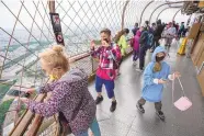  ?? MICHEL EULER/ASSOCIATED PRESS ?? Visitors enjoy the view from the top of the Eiffel Tower in Paris on July 16. The European Union has recommende­d that its member states restore restrictio­ns on tourists from the U.S., where cases are rising.