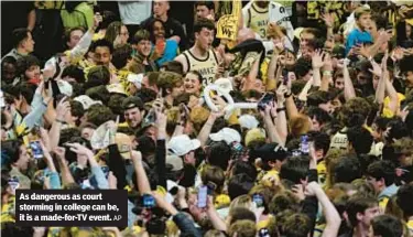  ?? AP ?? As dangerous as court storming in college can be, it is a made-for-TV event.