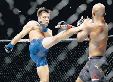  ?? CHRIS CARLSON/AP ?? Henry Cejudo, left, kicks Demetrious Johnson during their UFC flyweight title bout at UFC 227 in Los Angeles. Cejudo is scheduled to fight Dominick Cruz at UFC 249 in Jacksonvil­le on Saturday.