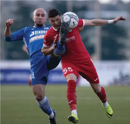  ??  ?? Balzan's Serbian striker Aleksa Andrejic (R) gets both the ball and the boot from the challenge coming from Mosta's Rafael Morisco. Photos © Domenic Aquilina