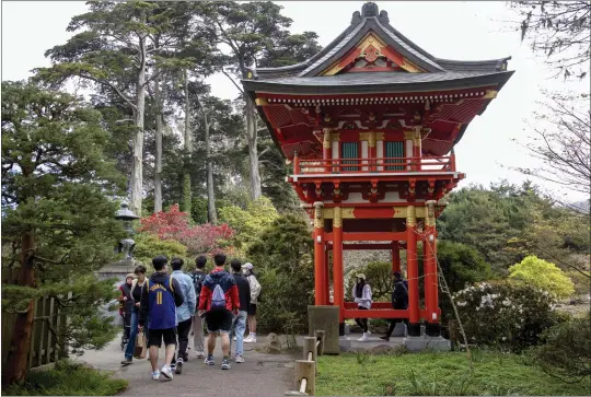  ?? PHOTOS BY KARL MONDON — BAY AREA NEWS GROUP ?? Visitors pass the Temple Gate at the Japanese Tea Garden in San Francisco's Golden Gate Park in March.