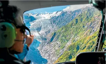  ??  ?? The short helicopter trip to land on the glacier offers spectacula­r views.