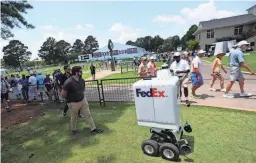  ?? JOE RONDONE/THE COMMERCIAL APPEAL ?? FedEx has pursued the use of robots for years, such as its experiment­al delivery robot Roxo.