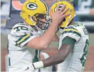  ?? DAN POWERS / USA TODAY NETWORK-WISCONSIN ?? Aaron Rodgers and Geronimo Allison celebrate their touchdown connection in the fourth quarter Sunday.