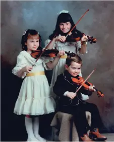  ??  ?? Left: Karrnnel at four years of age, with his two sisters Kimberly (right) and Kanndece. Together with their dad Orest on accordion (shown above with Karrnnel in his pre-teens), the foursome performed under the name The Sawitsky Family Fiddlers.