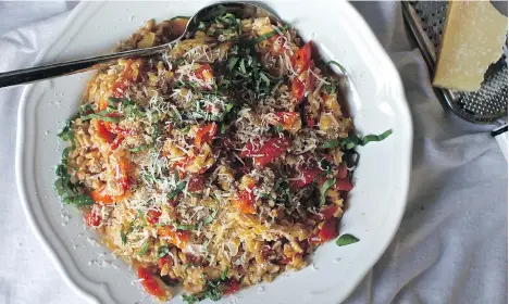  ??  ?? One-pan Farro with Tomatoes, from Deb Perelman’s Smitten Kitchen Every Day, is an easy dish to prepare. It pairs well with a bright white wine.