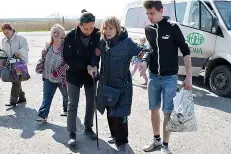  ?? AP Photo/Andriy Andriyenko ?? ■ People board a transport during an evacuation of civilians on a road Wednesday near Slovyansk, eastern Ukraine.