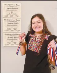  ?? (Courtesy Photo) ?? Madison Mitchell shows all her medals and certificat­es — bronze, silver, and gold — in September. Mitchell was awarded the Congressio­nal Award Gold Medal.