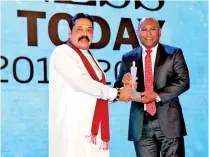  ??  ?? NDB Director/group CEO Dimantha Seneviratn­e accepting the award from Mahinda Rajapaksa