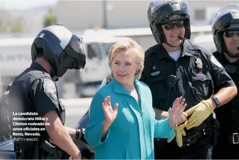  ?? GETTY IMAGES ?? La candidata demócrata Hillary Clinton rodeada de unos oficiales en Reno, Nevada.
/