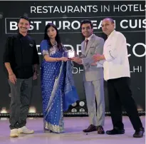  ?? ?? Vijay Thapliyal, executive chef, Nikhil Bhaskaran, assistant F&B manager, Prem Pal Singh, executive sous chef, The Lodhi, New Delhi, receive the award for Perbacco, the winner of Best European Cuisine.