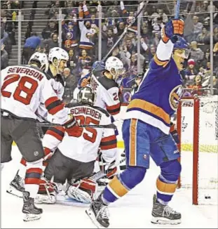  ??  ?? Anders Lee celebrates first-period goal as Islanders break skid at expense of Devils.