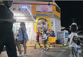 ?? Gerald Herbert Associated Press ?? ALTON STERLING is shown in a mural at the store where he was killed by police in 2016. Louisiana’s attorney general ruled out criminal charges in the case.