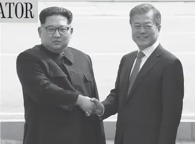  ?? KOREA BROADCASTI­NG SYSTEM VIA AP ?? North Korean leader Kim Jong Un, left, shakes hands with South Korean President Moon Jae-in at the border of the two countries Friday, before crossing into South Korea for historic face-to-face talks in Panmunjom.