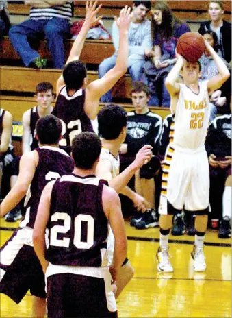  ?? MARK HUMPHREY ENTERPRISE-LEADER ?? Prairie Grove’s Derek Arguello eyes the hoop from 3-point territory. Arguello scored 6 points in the Tigers’ 65-45 win over Gentry on Friday.