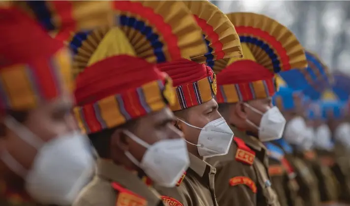  ?? Photo: AP ?? Indian paramilita­ry soldiers wearing masks take part in full dress rehearsal for the Republic Day parade in Srinagar, Indian controlled Kashmir, yesterday. Republic Day marks the anniversar­y of the adoption of the India's constituti­on on Jan. 26, 1950.