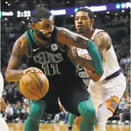  ?? Michael Dwyer / Associated Press ?? Boston’s Kyrie Irving starts to make a move against Phoenix’s Tyler Ulis in the Celtics’ win.