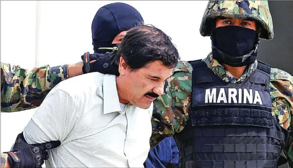  ??  ?? Joaquin Guzman Loera, aka “El Chapo” Guzman, is escorted by marines as he is presented to the press in Mexico City in 2014.