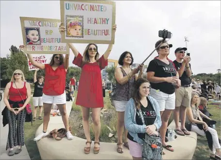  ?? Francine Orr Los Angeles Times ?? ABOUT 200 PROTESTERS gather outside Santa Monica City Hall in July to protest a strict new California law mandating vaccinatio­ns.