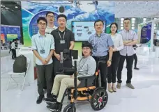  ?? PROVIDED TO CHINA DAILY ?? Zheng Dezhi, third right, and his team display their robotic wheelchair during this year’s Week for Innovation and Startups in Beijing.