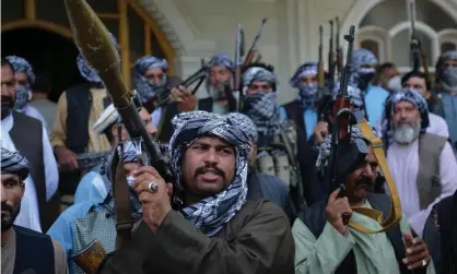  ?? Hashimi/AFP/Getty Images ?? Afghan militia gather with their weapons in Herat to support the security forces against the Taliban on Friday. Photograph: Hoshang