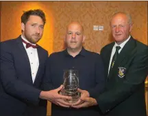  ??  ?? Pádraig Whitty (Pat Whitty’s son) presents the Pat Whitty Special Merit Award to North End Unitedmana­ger John Godkin, with Denis Hennessy, Chairman of the Wexford Football League, at the Horse and Hound player of the year awards.