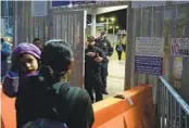  ?? GREGORY BULL AP FILE ?? A Guatemalan migrant asks U.S. border officials about asylum rules at the San Ysidro Port of Entry in May.