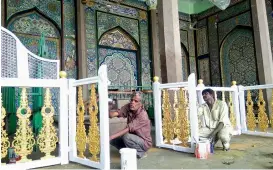  ?? — DC ?? Workers at the Badeshahi Ashoorkhan­a in Madina, near Charminar, paint the structure ahead of Muharram in the first week of October