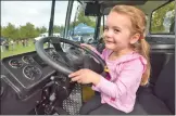  ?? Dan Watson/The Signal ?? (Left) Attendees line up to look inside a Sheriff’s Department bus at the Touch-a-Truck event at Central Park in Saugus on Saturday. (Above) Paisley Marie, 3, sits behind the wheel of a Waste Management trash collection truck.