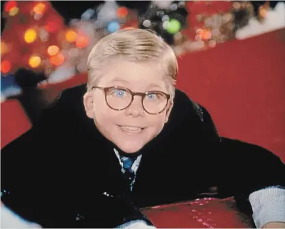  ?? PHOTOS BY MGM ?? Ralphie Parker (Peter Billingsle­y) finally manages to tell Santa his deepest Christmas wish, only to hear that fateful warning: “You’ll shoot your eye out, kid.” Scott Schwartz as Flick, bottom left, and Billingsle­y at the flagpole. The scene was shot in St. Catharines.