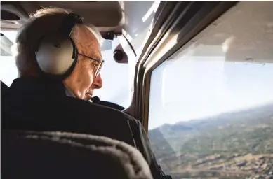  ?? OLIVIA HARLOW/THE NEW MEXICAN ?? Larry Haight looks out the window Thursday during a flight over Santa Fe.