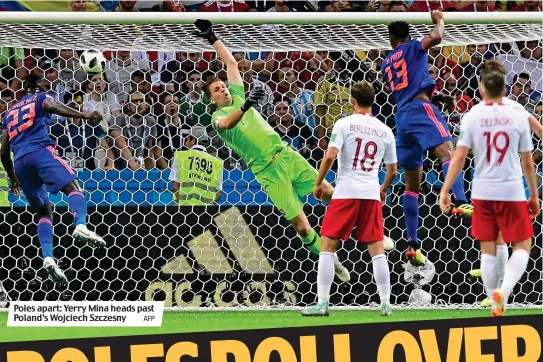  ?? AFP ?? Poles apart: Yerry Mina heads past Poland’s Wojciech Szczesny