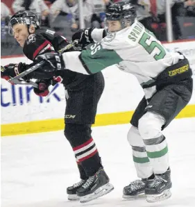  ?? TRURO NEWS PHOTO ?? Trey Faulkner of the Truro Bearcats takes a stick across the back from Jordan Spadafore of the Grand Falls Rapids during MHL action Friday at the RECC. The Bearcats held on for a 3-2 shootout win against the Rapids and downed South Shore Lumberjack­s 4-1 on Saturday.