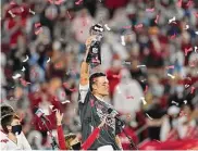  ?? Ashley Landis/Associated Press ?? Tampa Bay Buccaneers quarterbac­k Tom Brady holds up the Vince Lombardi trophy after defeating the Kansas City Chiefs in Super Bowl 55 on Feb. 7, 2021 in Tampa, Fla. Brady, the seven-time Super Bowl winner with New England and Tampa Bay, announced his retirement from the NFL on Wednesday.